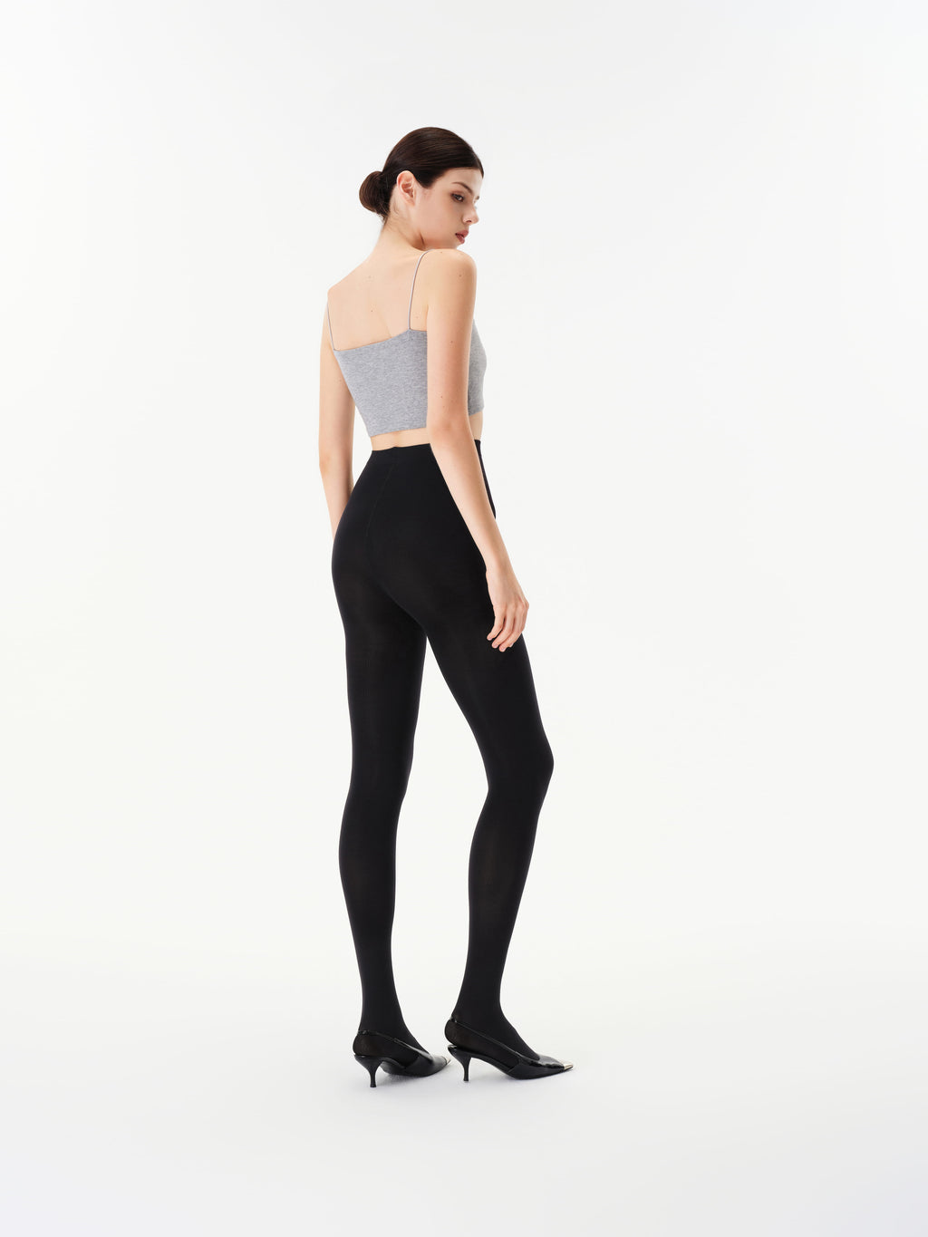 Rear three-quarter view of Yirane black opaque 80 denier tights.