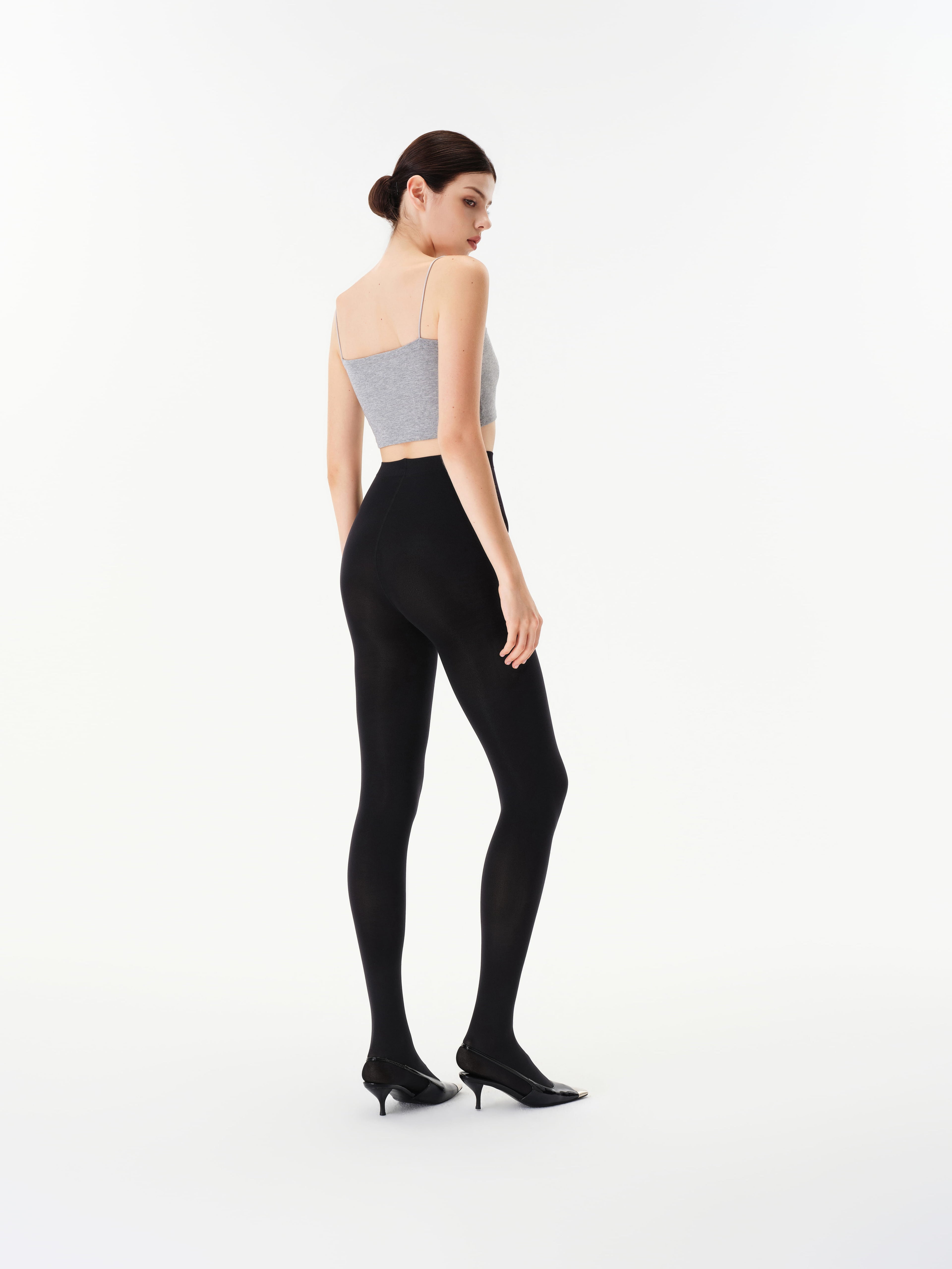 Rear three-quarter view of Yirane black opaque 80 denier tights.