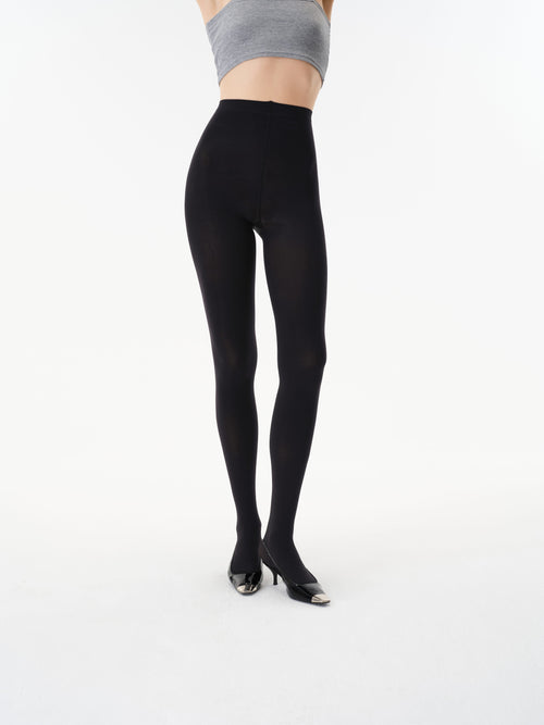 Front detail showing the high-rise waistband and opaque finish of Yirane black tights.