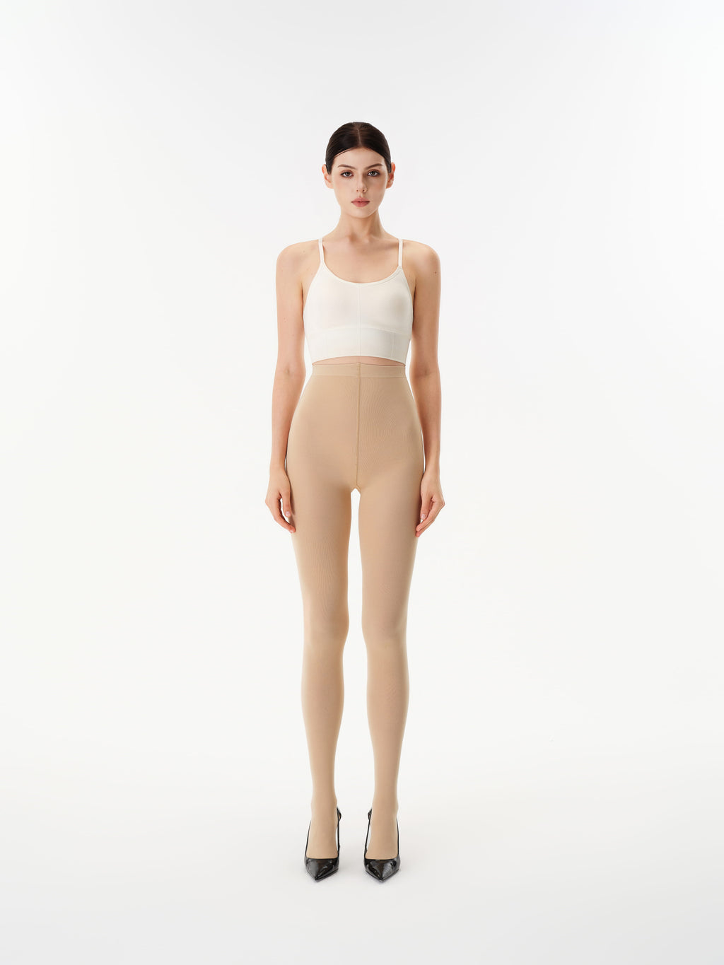 Model wearing Yirane porcelain nude opaque 80 denier tights, front view.
