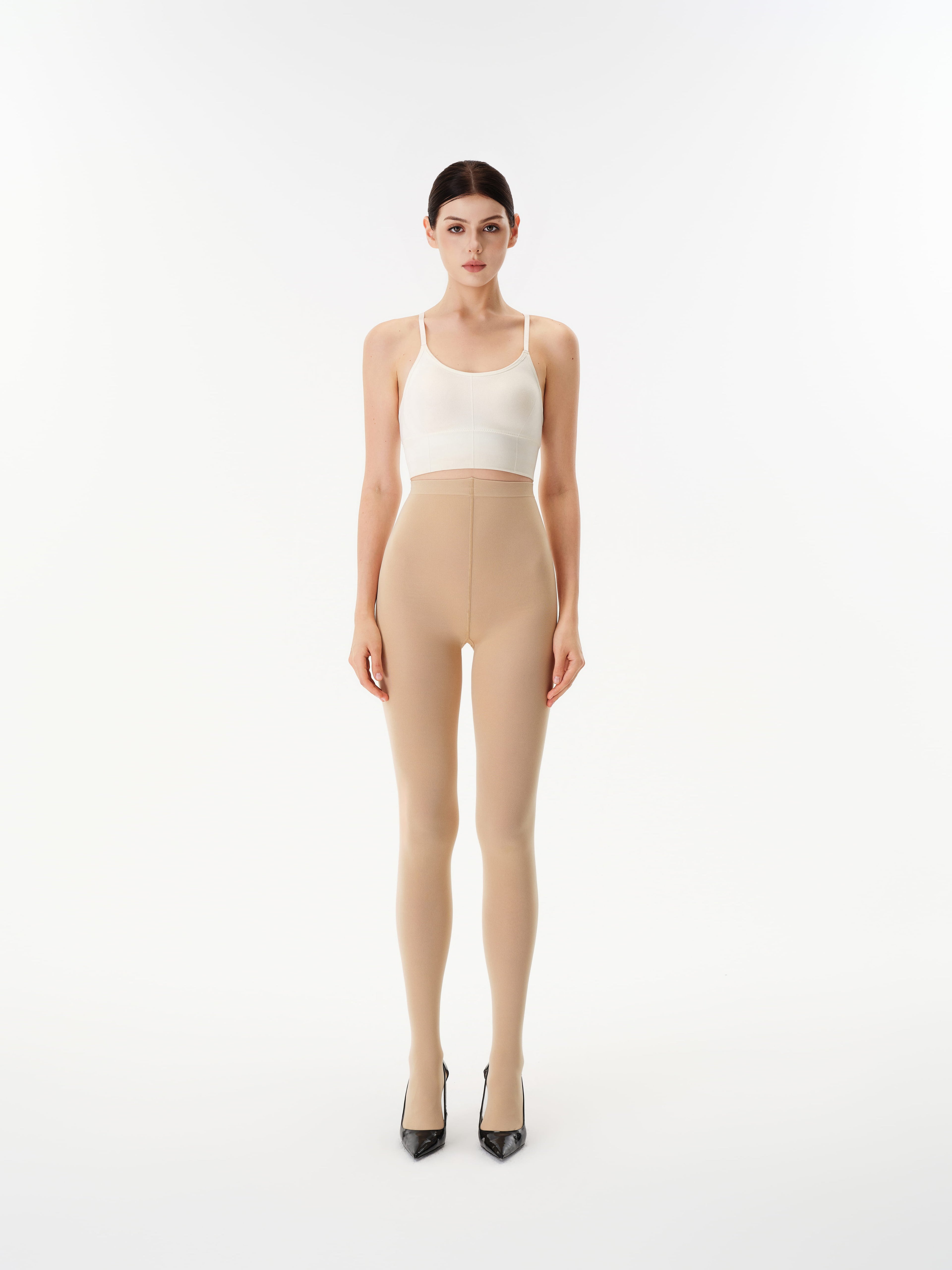 Model wearing Yirane porcelain nude opaque 80 denier tights, front view.