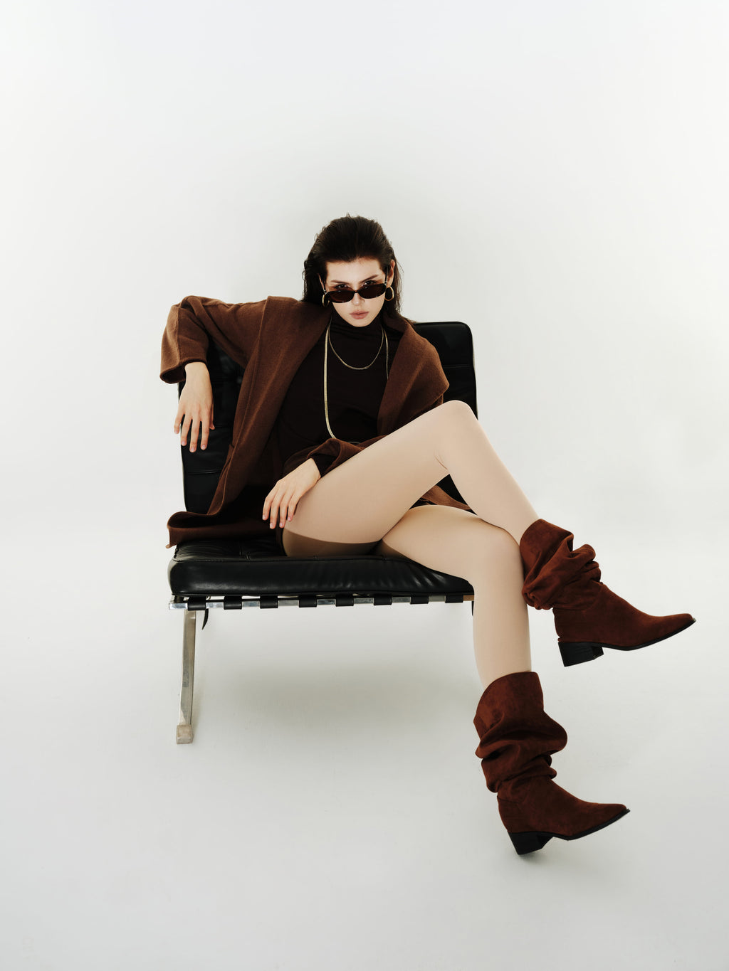 Model wearing Yirane porcelain nude opaque tights in a seated styled look.